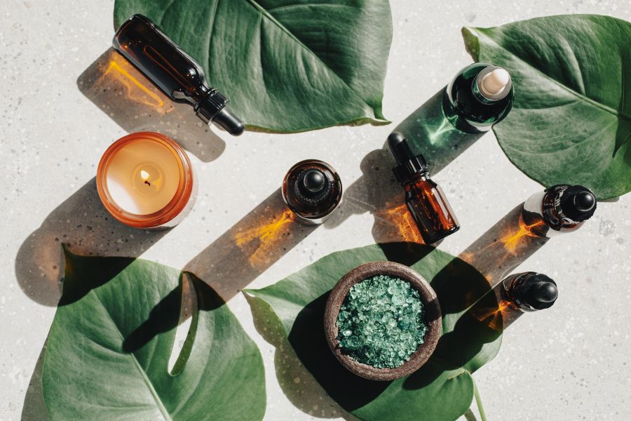 various cosmetic containers with green leaves
